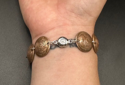 U.S. Wheat Penny Domed Coin Bracelet back on a wrist in front of a black background. - Mountainstruck Coin Jewelry
