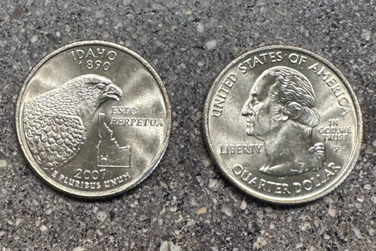 U.S. Idaho Quarter Coin on a concrete background. Back side of coin on left of image and front of coin on right side. - Mountainstruck Coin Jewelry