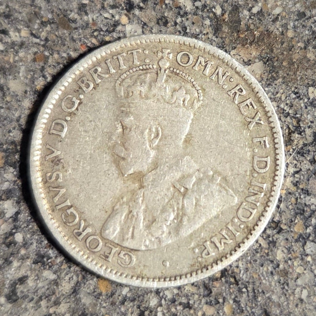 Australia emu kangaroo 6 pence silver coin front on concrete background- Mountainstruck Coin Jewelry
