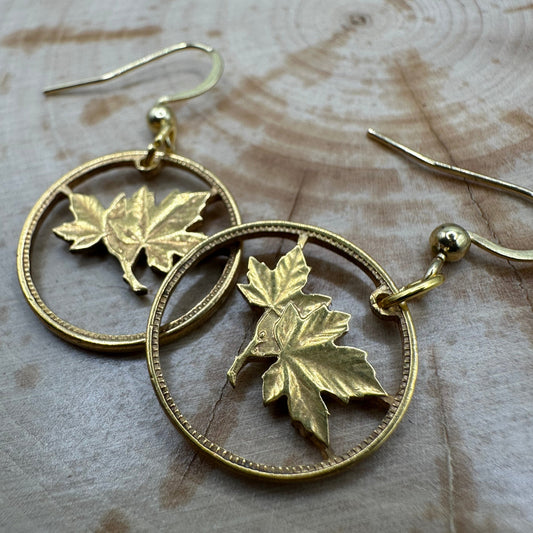 Canada Maple Leaf Hand Cut Coin Earrings 24k Gold Plated on wood background. - Mountainstruck Coin Jewelry