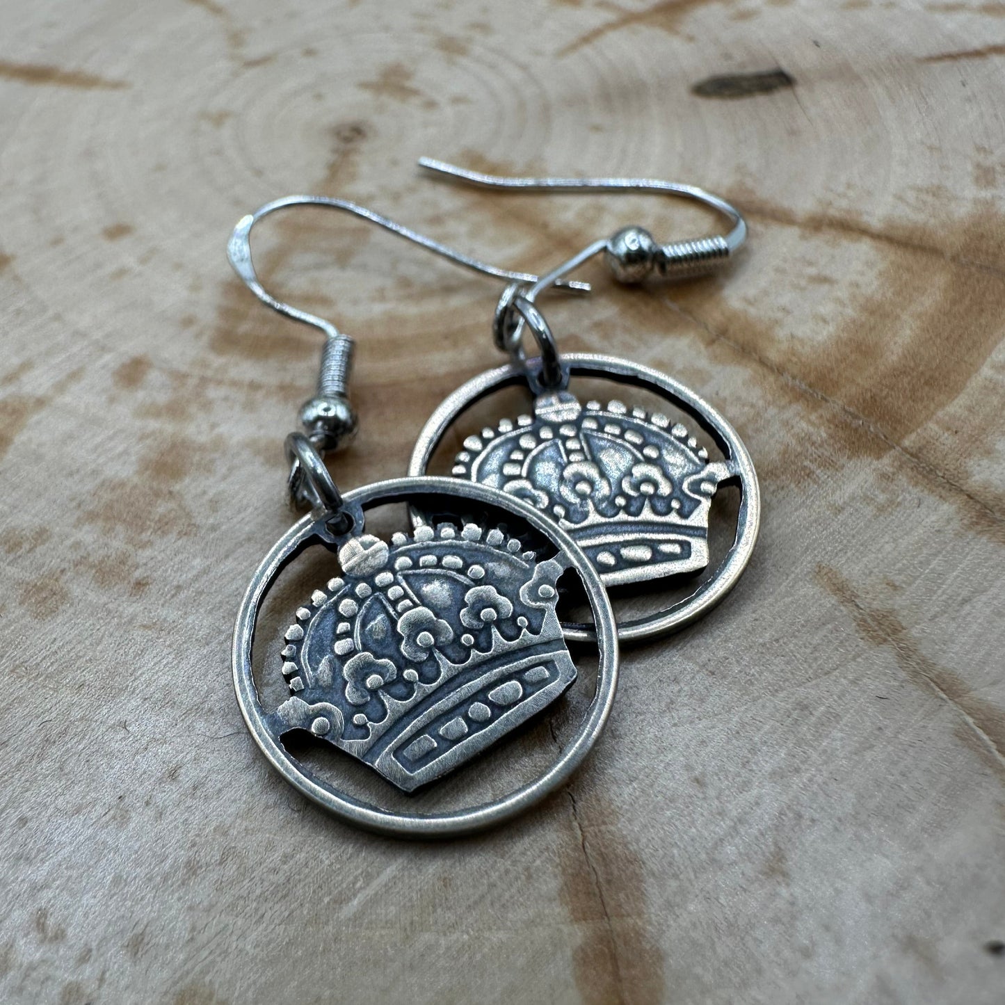 Sweden Crown 10 Ore Hand Cut Silver Coin Earrings on a wood background. - Mountainstruck Coin Jewelry