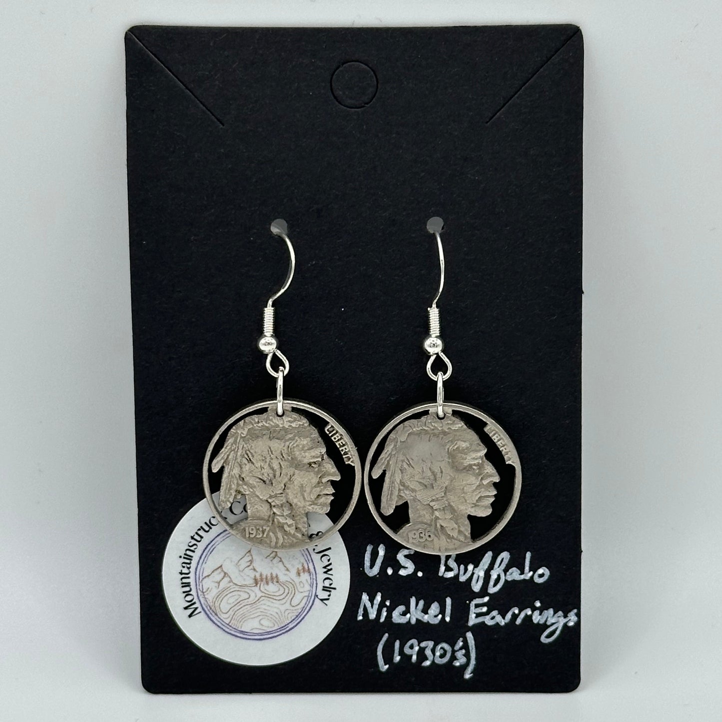 U.S. Buffalo Nickel Hand Cut Coin Earrings (Front) on black background with round Mountainstruck Coin Jewelry sticker in bottom left corner.
