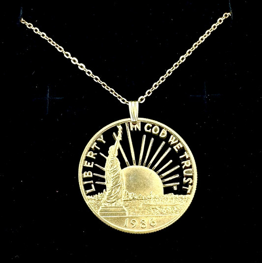 24k Plate U.S. Nation of Immigrants Cut Half Dollar Coin Necklace in a brown kraft box on a black velvet background. - Mountainstruck Coin Jewelry