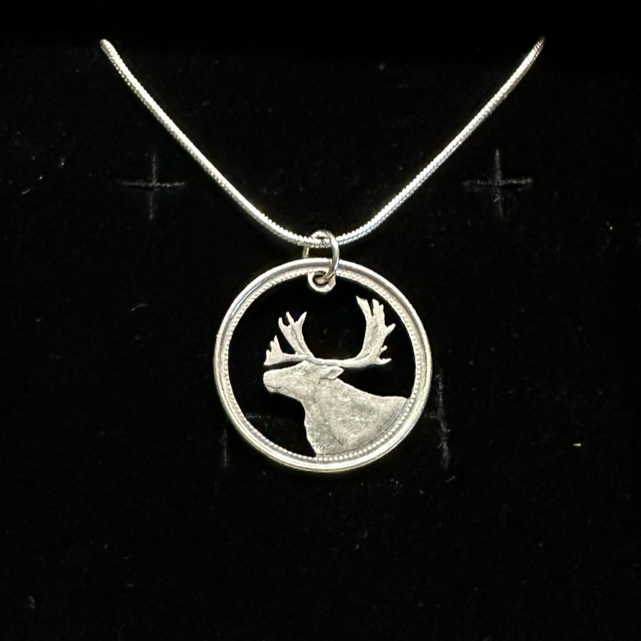 Canada Caribou 25 Cents hand cut coin necklace with a snake chain on a black velvet background. - Mountainstruck Coin Jewelry