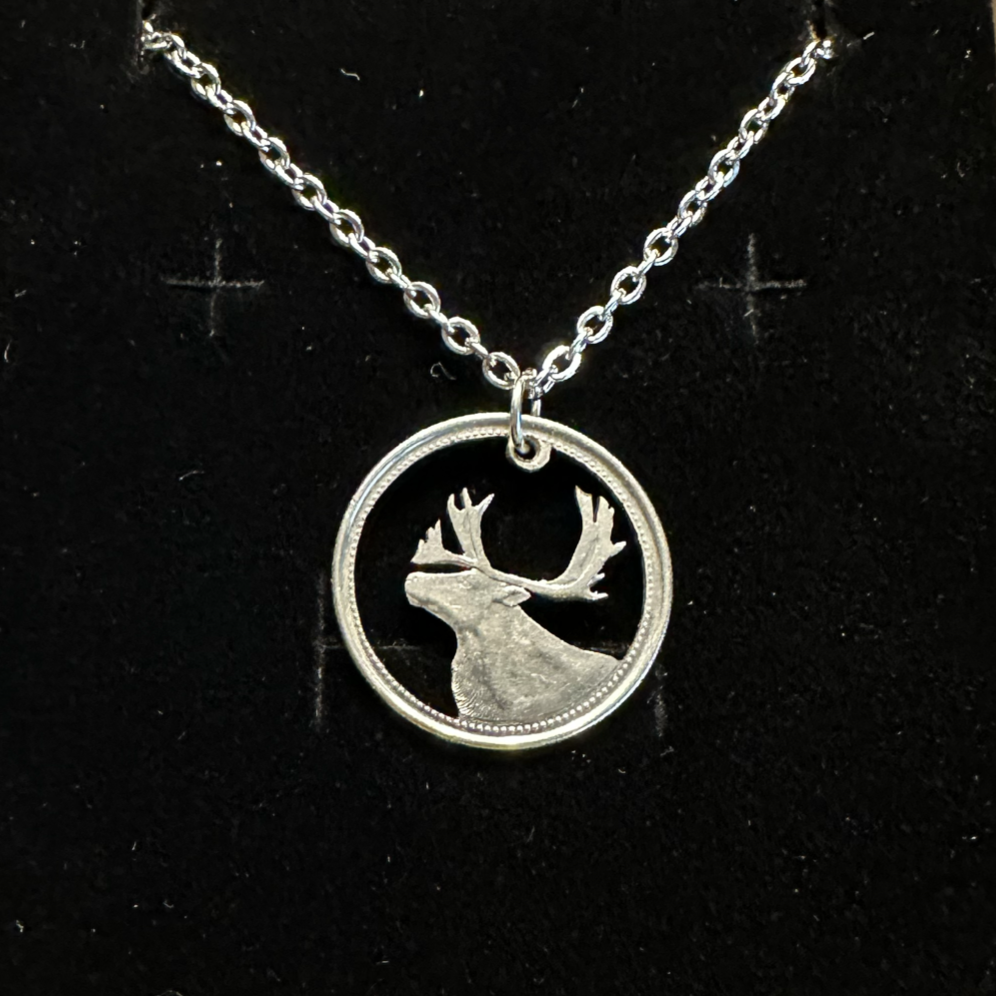 Canada Caribou 25 Cents hand cut coin necklace on a black velvet background. - Mountainstruck Coin Jewelry