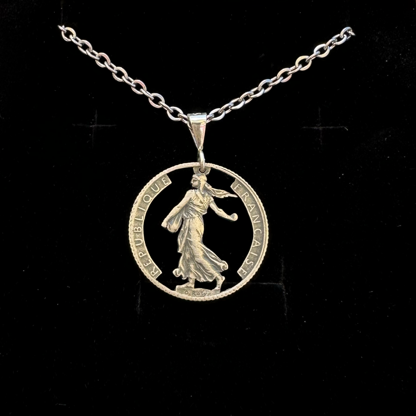 France 1 Franc Silver Hand Cut Coin Necklace in a brown kraft box on a black velvet background. - Mountainstruck Coin Jewelry