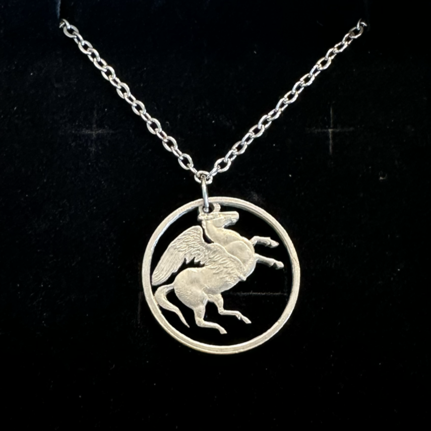 Greece Pegasus 5 Drachmai Hand Cut Coin Necklace with a stainless chain on a black velvet background. - Mountainstruck Coin Jewelry
