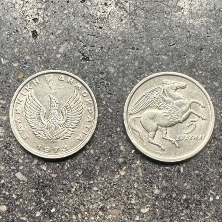 Greece Pegasus 5 Drachmai Coin on a concrete background. Front side of coin on the left and back side of coin on the right side of the picture. - Mountainstruck Coin Jewelry