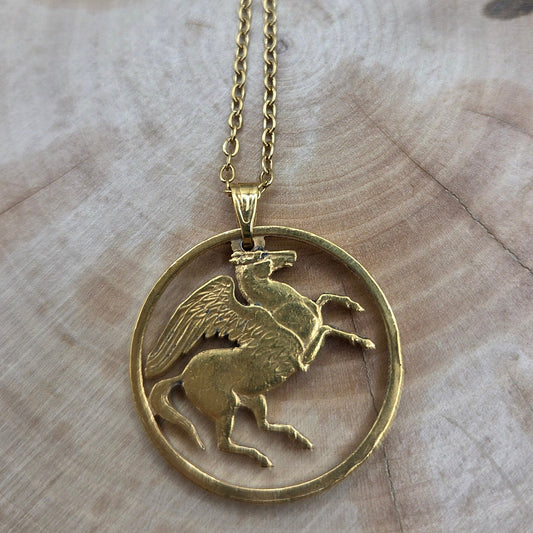 Greece Pegasus 5 Drachmai Hand Cut Coin Necklace gold plated with a gold plated chain on a wood background. - Mountainstruck Coin Jewelry