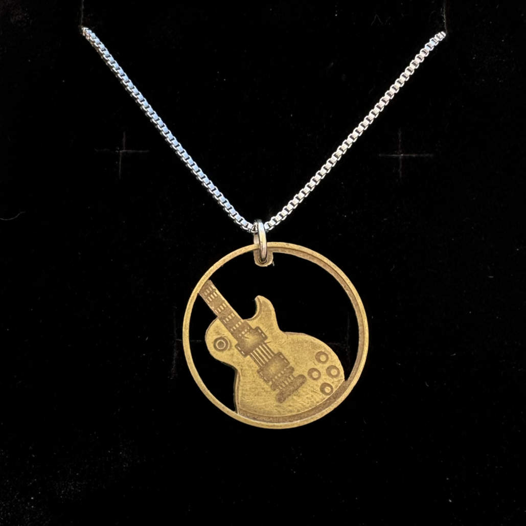 Guitar Token Hand Cut Token Necklace in a brown kraft box on a black velvet background. - Mountainstruck Coin Jewelry