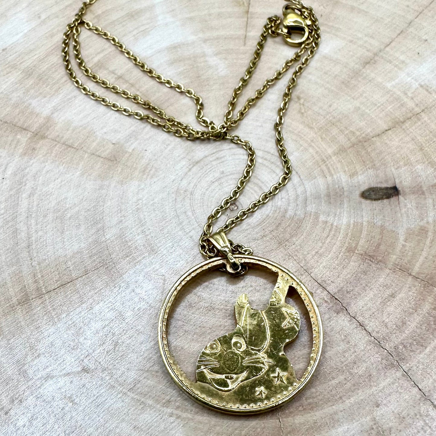 Guitar Hand Cut Token Necklace on a light wood round. - Mountainstruck Coin Jewelry