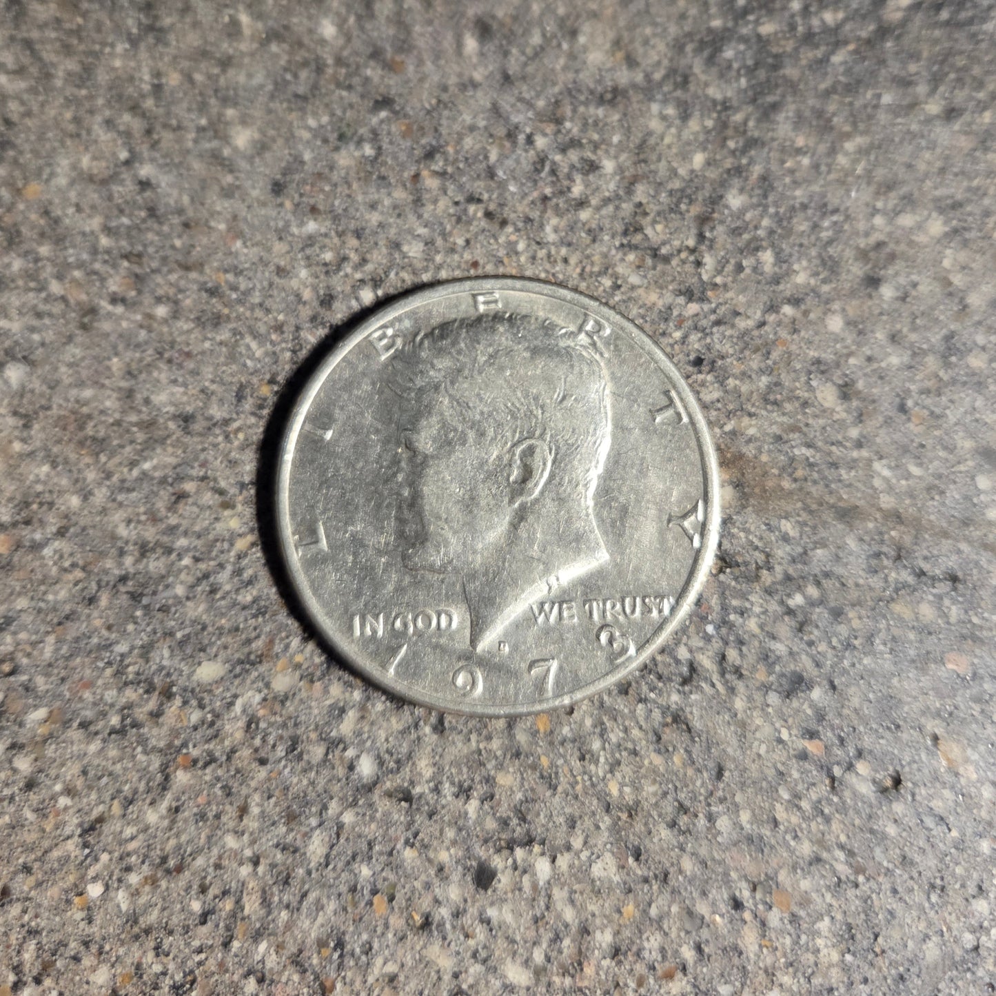 U.S. Half Dollar coin front on a concrete background. - Mountainstruck Coin Jewelry