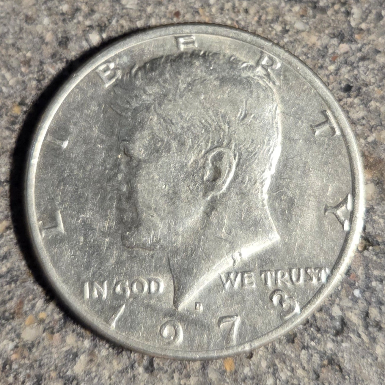 U.S. Half Dollar coin front on a concrete background. - Mountainstruck Coin Jewelry