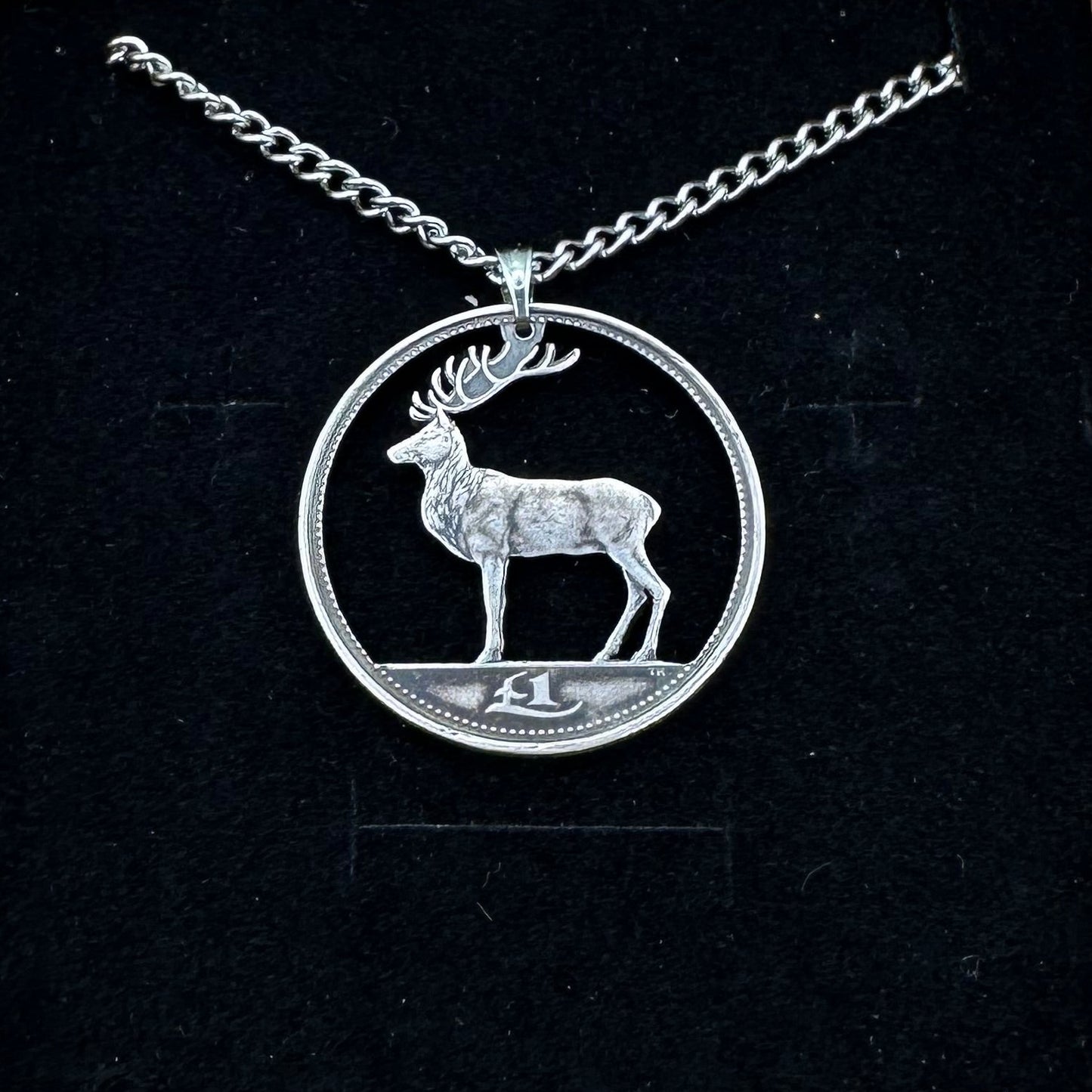 Irish Red Deer Hand Cut Coin Necklace on a black velvet background. - Mountainstruck Coin Jewelry