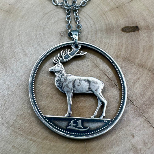 Ireland Red Deer Hand Cut Coin Necklace on a wood round. - Mountainstruck Coin Jewelry