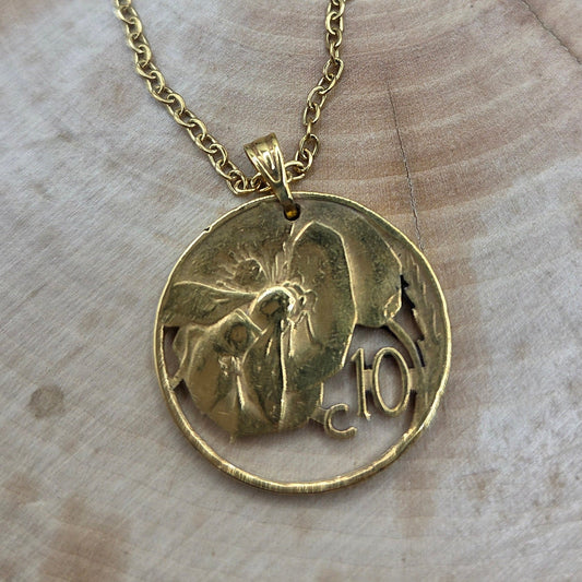 Honeybee Italy 10 Centesimi Hand Cut Coin Necklace on a wood background. - Mountainstruck Coin Jewelry