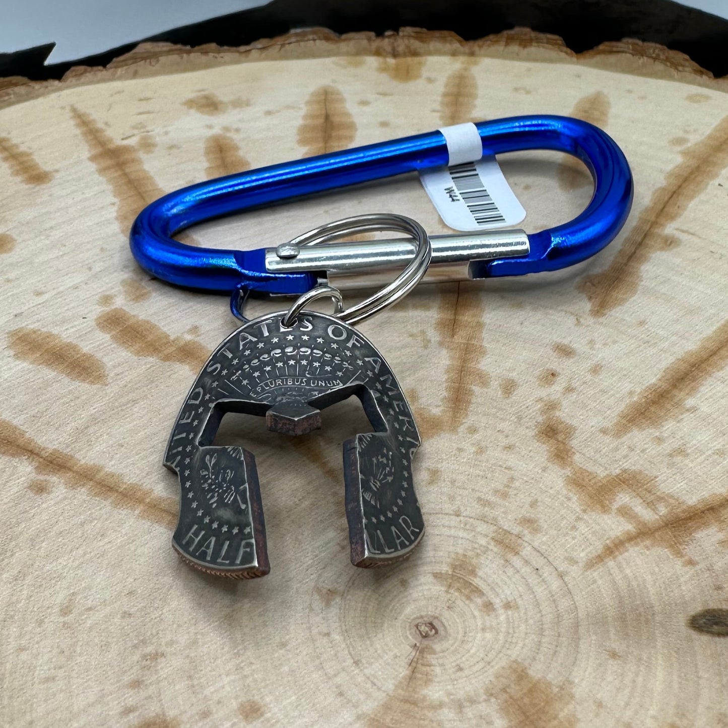 Hand cut and molded Spartan Helmet made from a U.S. Half Dollar on a blue carabiner . - Mountainstruck Coin Jewelry