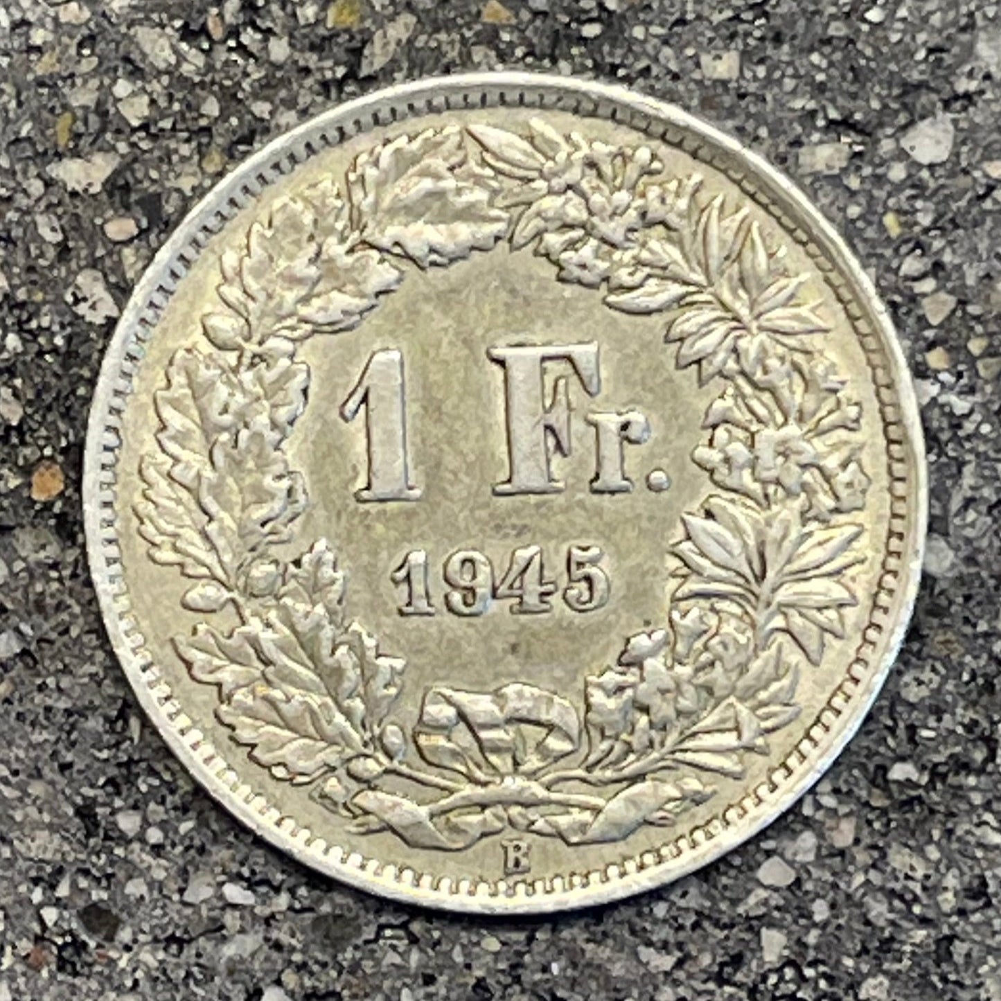 Silver Lady Swiss 1 Franc Coin back on a concrete background. - Mountainstruck Coin Jewelry