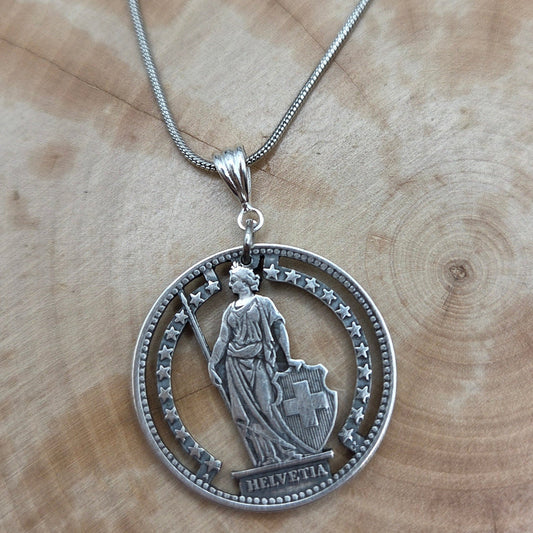 Swiss Lady 1 Franc Silver Hand Cut Coin Necklace on a wood background. - Mountainstruck Coin Jewelry