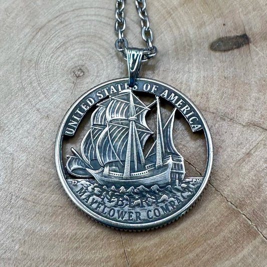 U.S. 2026 "Mayflower" Quarter Hand Cut Coin Necklace front with a stainless chain on a wood background. - Mountainstruck Coin Jewelry