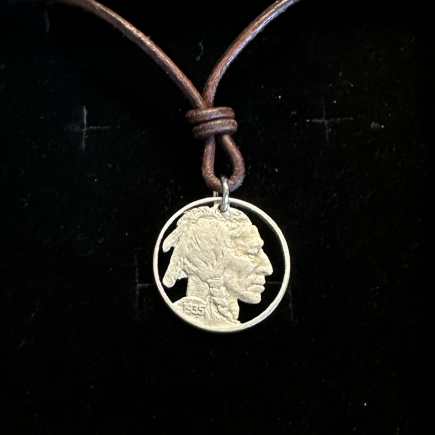 U.S. Buffalo Nickel Hand Cut Coin Necklace (Front) with a leather cord in brown kraft box on black velvet background. - Mountainstruck Coin Jewelry