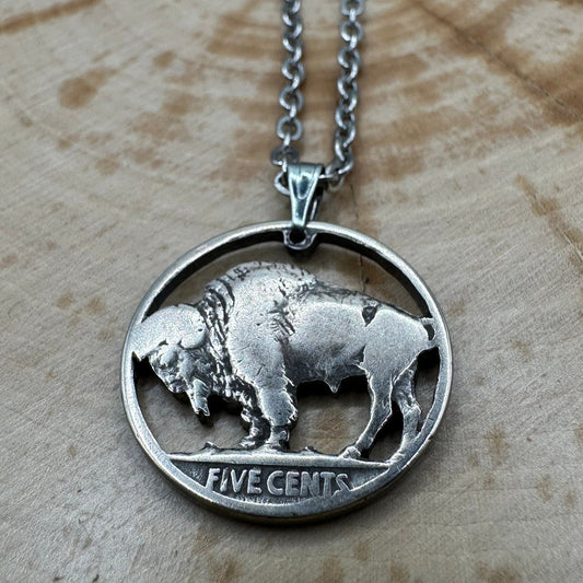 U.S. Buffalo Nickel Hand Cut Coin Necklace (Back) with a stainless chain on a wood background. - Mountainstruck Coin Jewelry