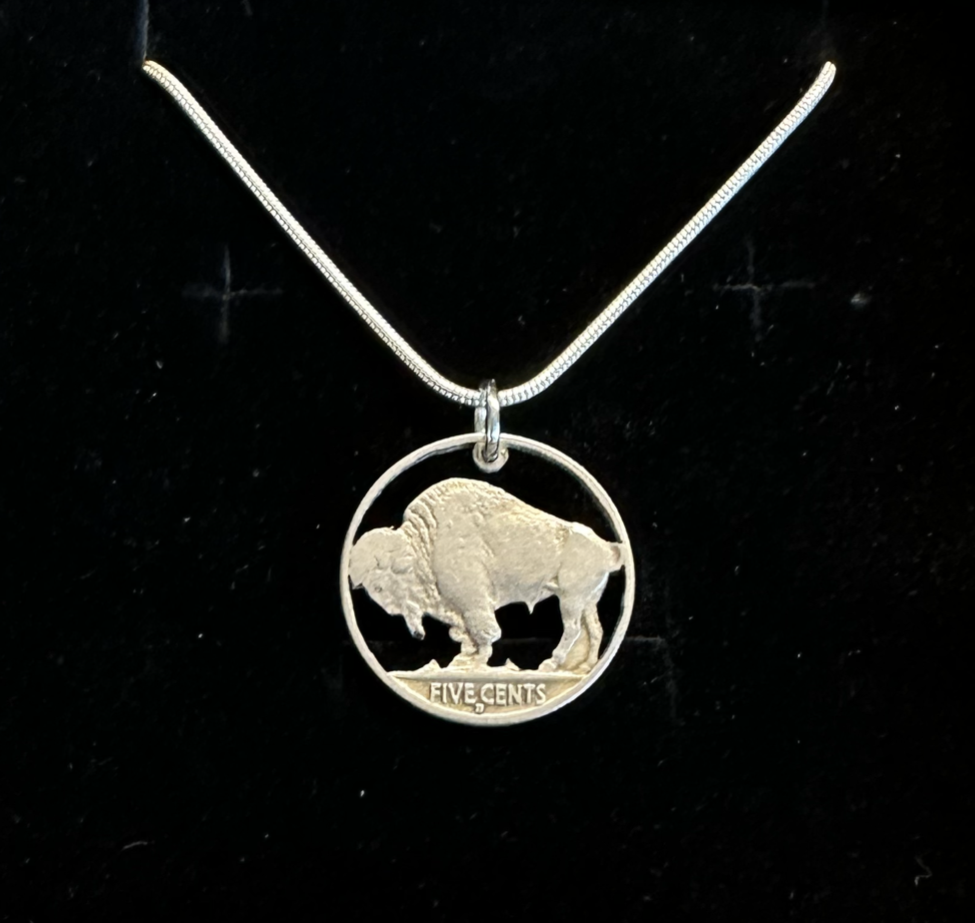 U.S. Buffalo Nickel Hand Cut Coin Necklace (Back) with a snake chain in a brown kraft box on a black velvet background. - Mountainstruck Coin Jewelry