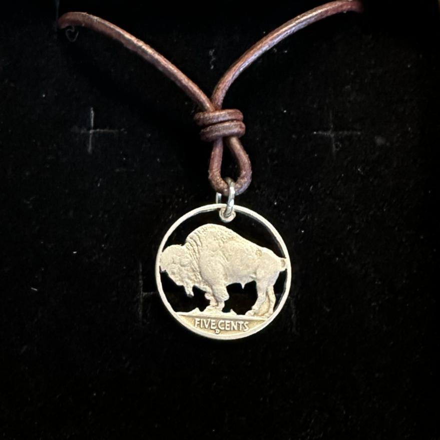 U.S. Buffalo Nickel Hand Cut Coin Necklace (Back) with a leather cord in a brown kraft box on a black velvet background. - Mountainstruck Coin Jewelry