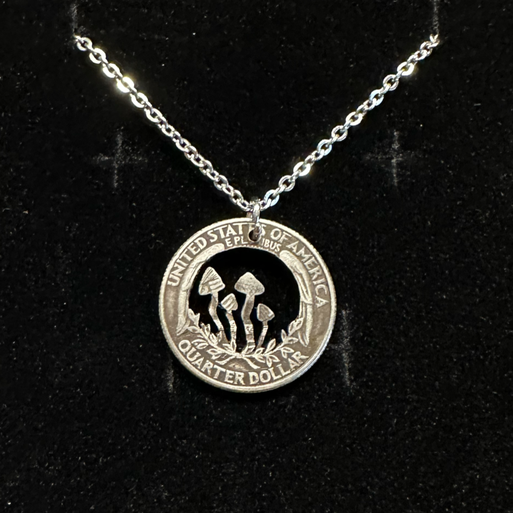 U.S. Custom Mushroom Quarter Hand Cut Coin Necklace with stainless chain on a black velvet background.- Mountainstruck Coin Jewelry
