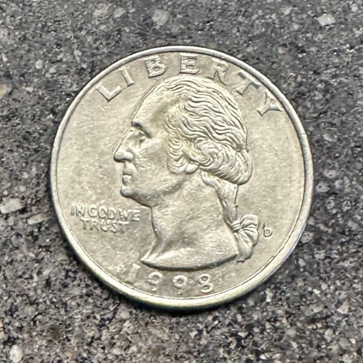 Front of U.S. Quarter on a concrete background. - Mountainstruck Coin Jewelry
