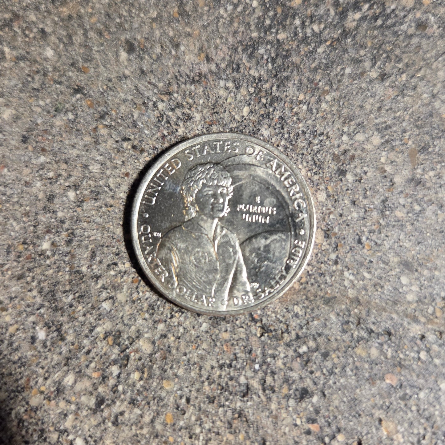 U.S. First American Woman in Space Coin back on a concrete background. - Mountainstruck Coin Jewelry