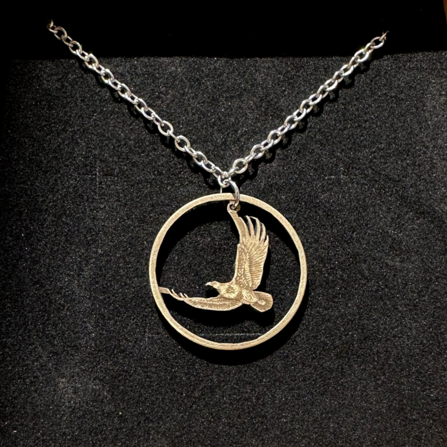 U.S. Flying Eagle Sacagawea One Dollar Hand Cut Coin Necklace on a black velvet background. - Mountainstruck Coin Jewelry