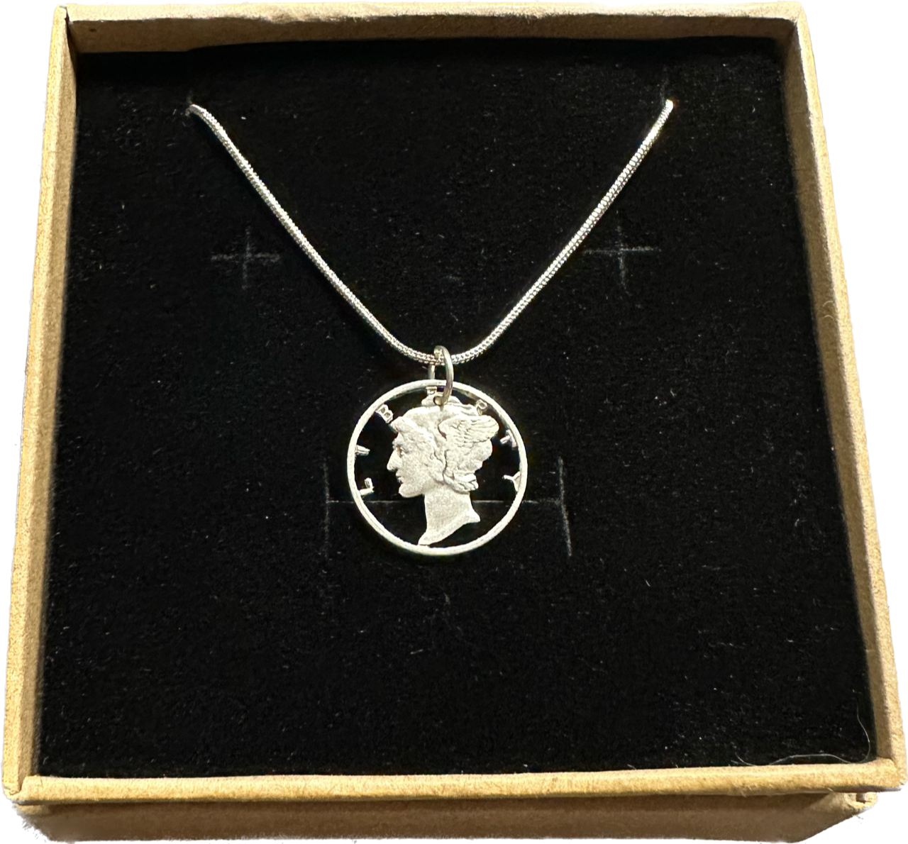 U.S. Mercury Dime Silver Hand Cut Coin Necklace (snake chain) in a brown kraft box on a black velvet background. - Mountainstruck Coin Jewelry