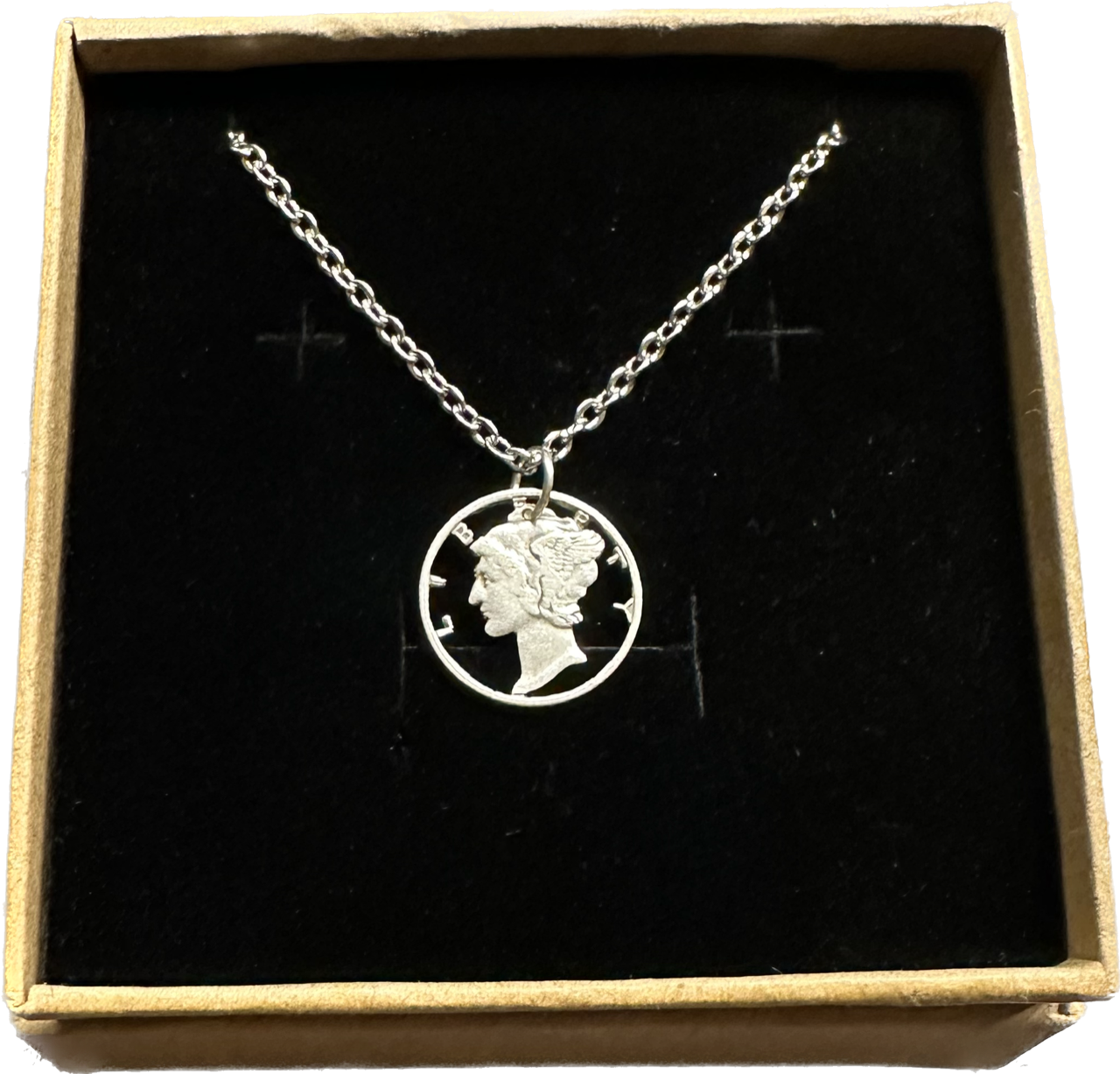 U.S. Mercury Dime Silver Hand Cut Coin Necklace (stainless chain) in a brown kraft box on a black velvet background. - Mountainstruck Coin Jewelry