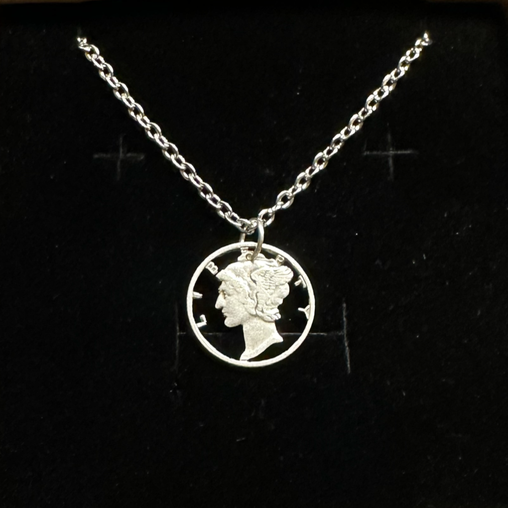U.S. Mercury Dime Silver Hand Cut Coin Necklace (stainless chain) in a brown kraft box on a black velvet background. - Mountainstruck Coin Jewelry