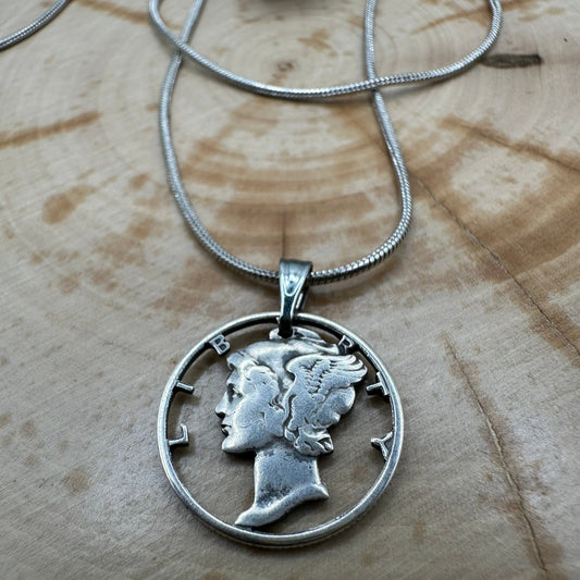 U.S. Mercury Dime Silver Hand Cut Coin Necklace (snake chain) in a brown kraft box on a wood background. - Mountainstruck Coin Jewelry