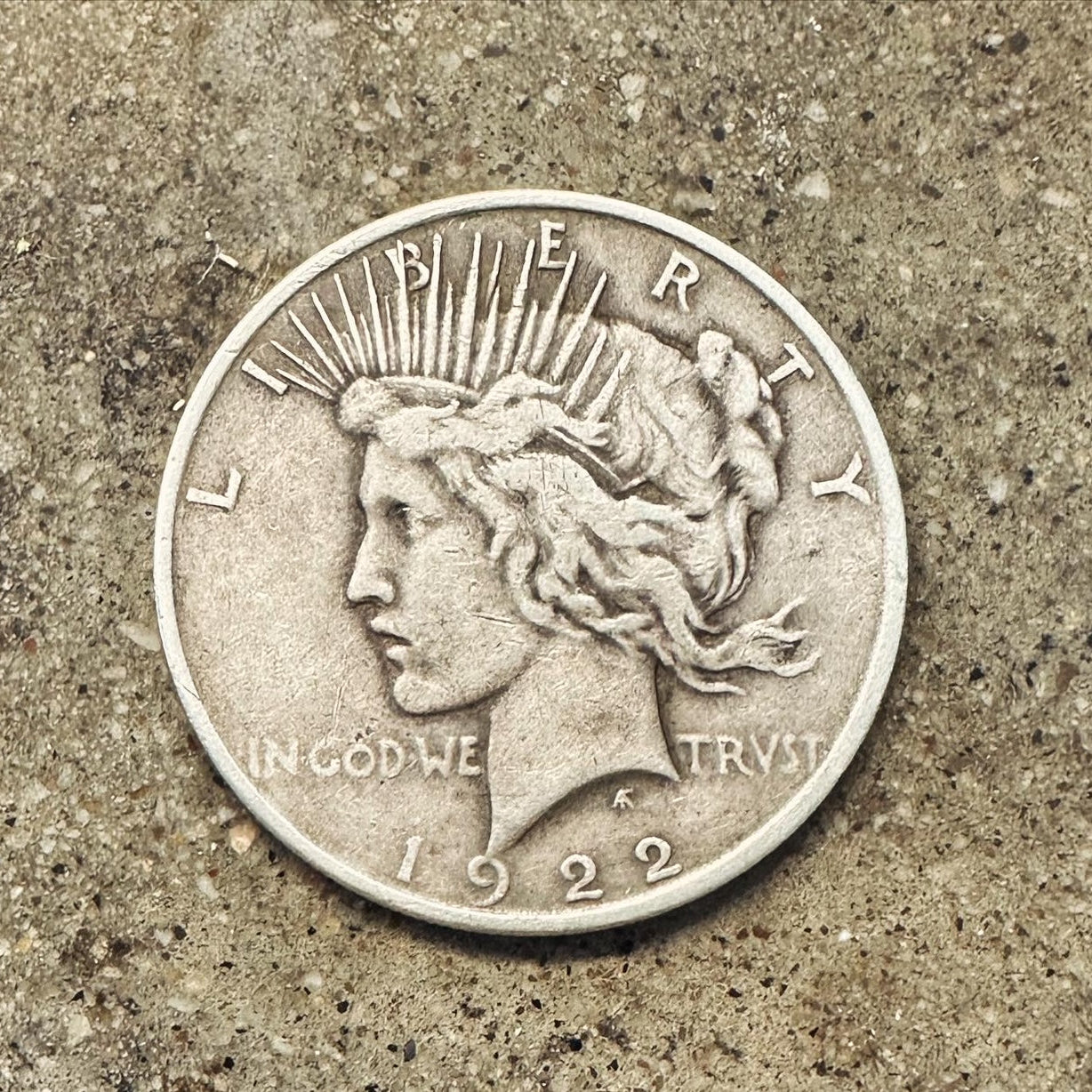 U.S. Peace Dollar Silver Coin
front on a concrete background. - Mountainstruck Coin Jewelry