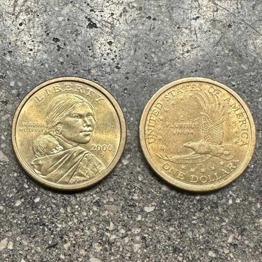 Sacagawea 1 Dollar Coin front on left side of picture and back of coin on right side on a concrete background. - Mountainstruck Coin Jewelry