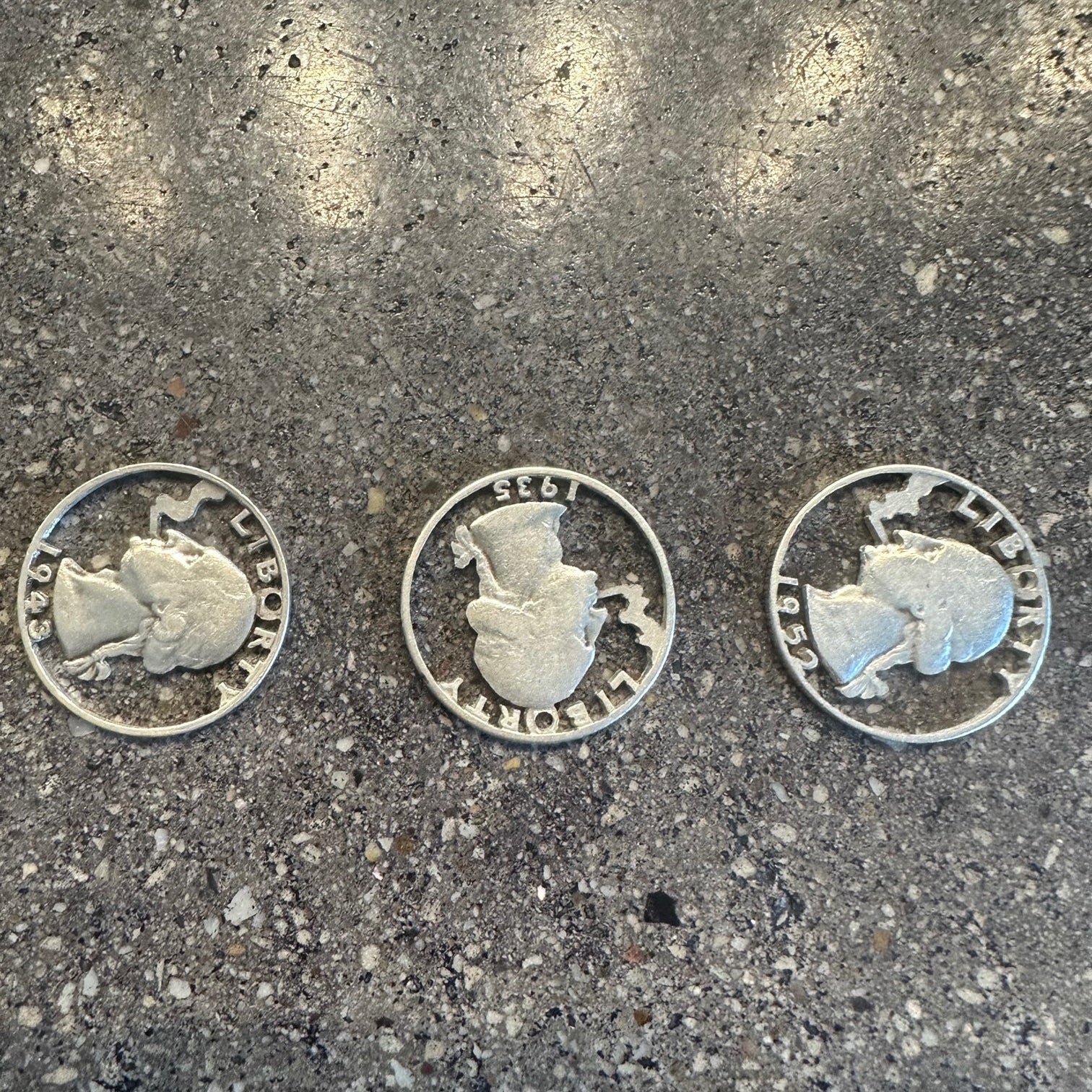 U.S. Smoking GW Silver Quarter Hand Cut Coins on a concrete background. - Mountainstruck Coin Jewelry