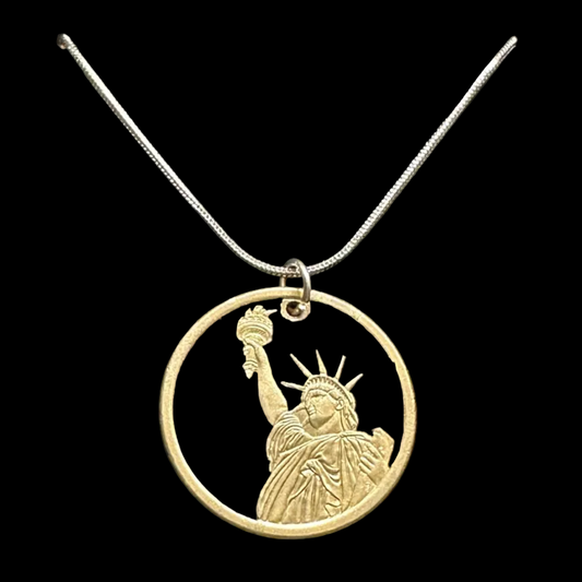 U.S. Statue of Liberty Dollar Hand Cut Coin Necklace with a snake chain in a brown kraft box on a black velvet background. - Mountainstruck Coin Jewelry