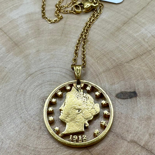 U.S. "V" Nickel Hand Cut Coin Necklace with a gold plated chain with a wood background. - Mountainstruck Coin Jewelry
