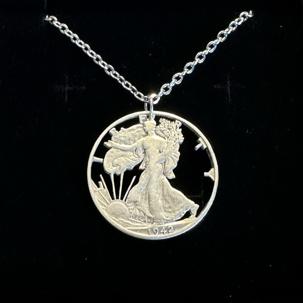 U.S. Walking Liberty Silver Hand Cut Coin Necklace (Lady Liberty) with a stainless chain in a brown kraft box on a black velvet background. - Mountainstruck Coin Jewelry