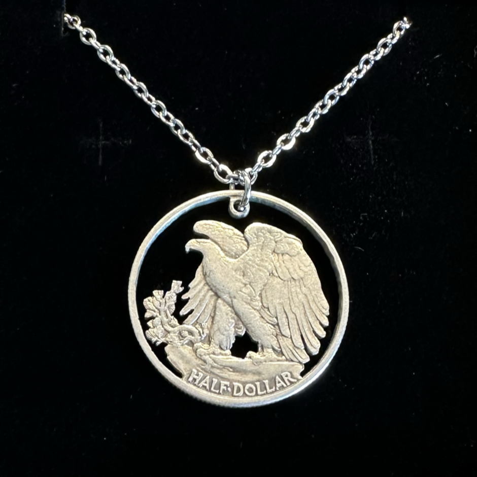 U.S. Walking Liberty Silver Hand Cut Coin Necklace (Eagle) with a stainless chain in a brown kraft box on a black velvet background. - Mountainstruck Coin Jewelry