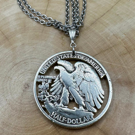 U.S. Walking Liberty Silver Hand Cut Coin Necklace (Eagle) with a snake chain on a light wood background. - Mountainstruck Coin Jewelry