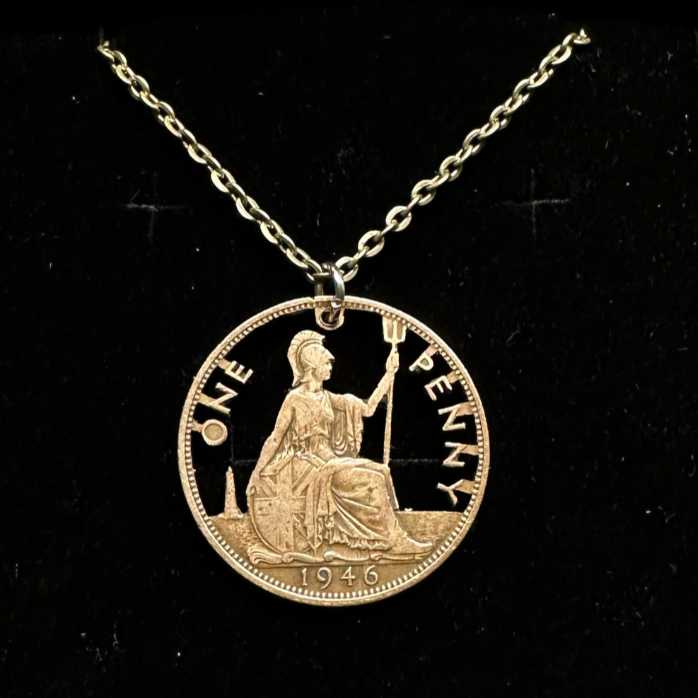 UK One Penny Hand Cut Coin Necklace with a stainless chain in a brown kraft box on a black velvet background. - Mountainstruck Coin Jewelry