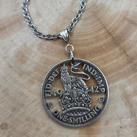 UK One Shilling Hand Cut Silver Coin Necklace with stainless chain on a wood background. - Mountainstruck Coin Jewelry