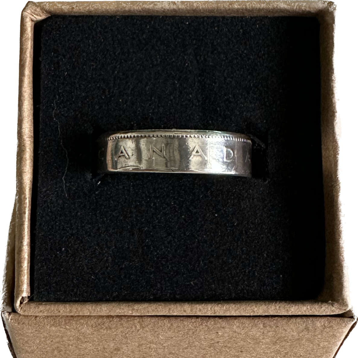 Canada 25 Cents Silver Coin Ring in a brown kraft box on a black velvet background. - Mountainstruck Coin Jewelry