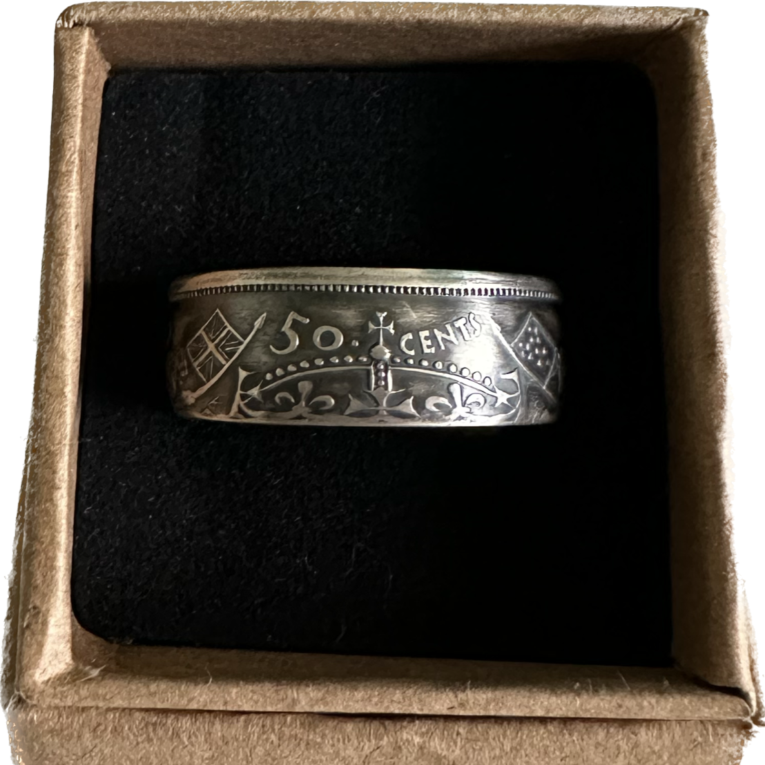 Canada 50 Cents Silver Coin Ring (Lion + Unicorn) in a brown kraft box on a black velvet background. - Mountainstruck Coin Jewelry