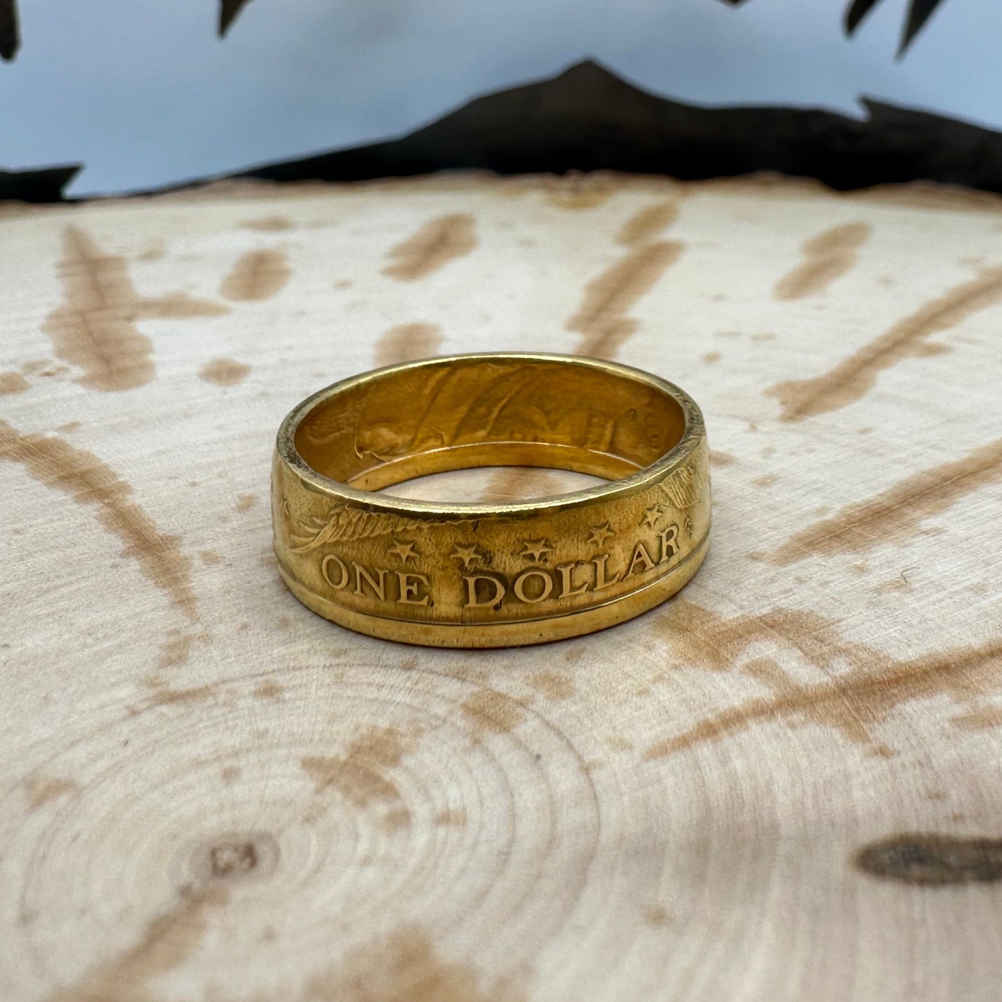 Gold Plated U.S. Presidential Dollar Coin Ring on a wood background. - Mountainstruck Coin Jewelry