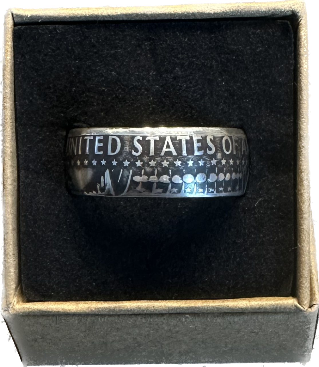 JFK Silver Half Dollar Coin Ring (reverse) in a brown kraft box on a black velvet background. - Mountainstruck Coin Jewelry